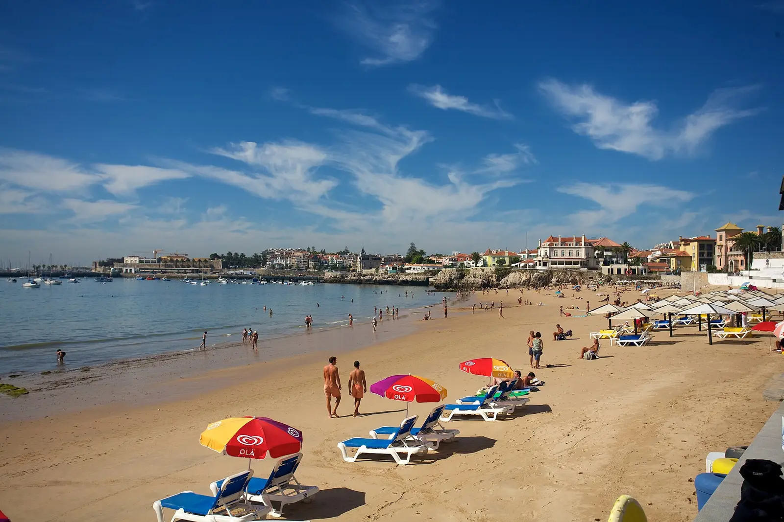 Beach with parasols and sun loungers on the seafront at Estoril