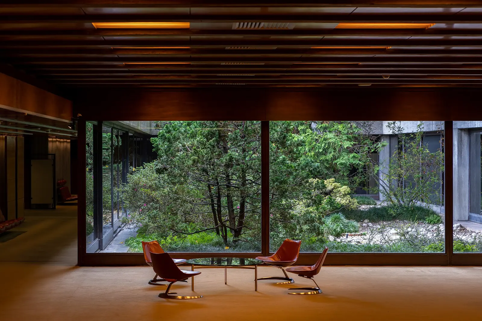 Wood-panelled interior of the Calouste Gulbenkian Foundation headquarters opening onto its garden