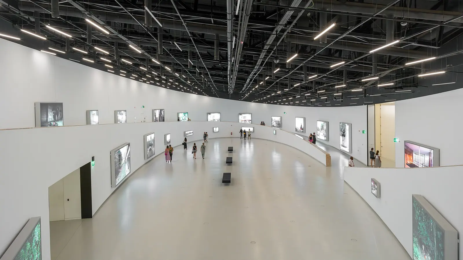 Visitors in the curved Oval Gallery at MAAT in Lisbon