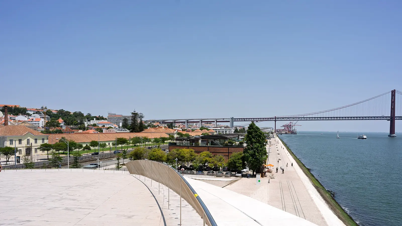 View from the MAAT rooftop toward the 25 de Abril Bridge and the Lisbon waterfront
