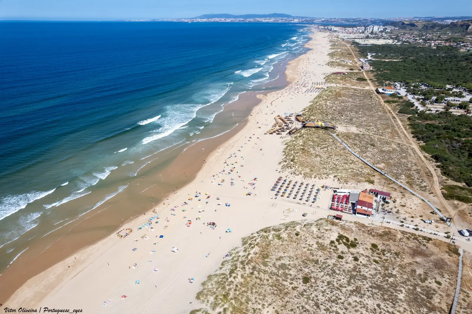 Aerial view of Praia do Castelo beach and dunes at Costa da Caparica